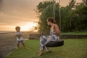 mother and child playing on a swing